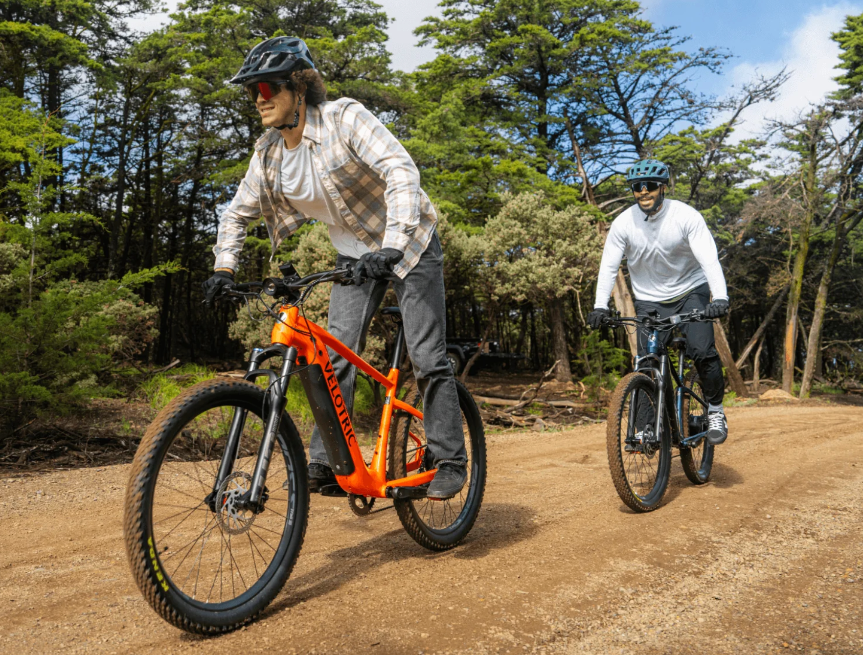 Two adults ride mountain bikes on a trail in Alabama.